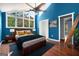 Airy blue bedroom with tall windows, hardwood floors, closet and cozy furnishings at 1213 Laurel Cliff Se Dr, Smyrna, GA 30082