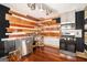 Efficient kitchen equipped with stainless steel appliances, custom shelving, and hardwood flooring at 1213 Laurel Cliff Se Dr, Smyrna, GA 30082