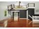 Open-concept living room showcasing a modern spiral staircase and gleaming hardwood floors at 1213 Laurel Cliff Se Dr, Smyrna, GA 30082