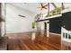 Open living area with spiral stairs, an overhead loft, and gleaming hardwood floors at 1213 Laurel Cliff Se Dr, Smyrna, GA 30082