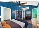 Stylish main bedroom with blue walls, hardwood floors, and a unique ladder leading to an elevated loft space at 1213 Laurel Cliff Se Dr, Smyrna, GA 30082