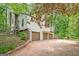 Expansive three-car garage with ample parking and a private balcony overlooking the lush surroundings at 1213 Laurel Cliff Se Dr, Smyrna, GA 30082