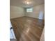 A bright bedroom with a window and wood-look flooring at 140 Clover Valley Dr, Covington, GA 30016
