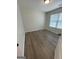 A bright bedroom featuring a window and wood-look flooring at 140 Clover Valley Dr, Covington, GA 30016