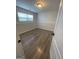 A bright bedroom featuring a window and wood-look flooring at 140 Clover Valley Dr, Covington, GA 30016