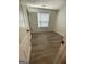 A well-lit bedroom with a window and wood-look flooring at 140 Clover Valley Dr, Covington, GA 30016