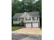 Charming two-story home featuring a two-car garage, landscaped front yard, and traditional design at 140 Clover Valley Dr, Covington, GA 30016