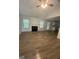 Bright living room featuring a fireplace, hardwood floors, and large windows for natural light at 140 Clover Valley Dr, Covington, GA 30016