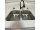 Modern kitchen sink featuring a double basin, modern faucet, and quartz countertops at 140 Clover Valley Dr, Covington, GA 30016