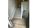 Stairway featuring neutral colors, newel posts and hardwood flooring at 140 Clover Valley Dr, Covington, GA 30016