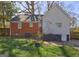View of the backyard showing grass and the home's rear exterior of white siding and red brick at 3464 Wren Rd, Decatur, GA 30032