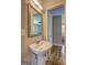 Bright bathroom featuring a pedestal sink with a mirror and modern fixtures at 3464 Wren Rd, Decatur, GA 30032