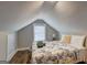 Charming bedroom with a patterned quilt, sloped ceiling, and a window for natural light at 3464 Wren Rd, Decatur, GA 30032