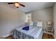 Comfortable bedroom with a window, ceiling fan, and hardwood floors at 3464 Wren Rd, Decatur, GA 30032