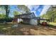 Spacious backyard with deck, covered patio, and lush landscaping, perfect for outdoor entertaining at 402 Emmett St, Riverdale, GA 30274