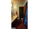 Small bathroom with sink, mirror, and toilet behind an open door at 402 Emmett St, Riverdale, GA 30274