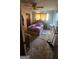Bedroom with textured carpet, ceiling fan, and a double bed beneath a window with natural light at 402 Emmett St, Riverdale, GA 30274