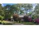 View of the home's exterior showing the carport, driveway, and mature landscaping at 402 Emmett St, Riverdale, GA 30274