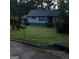 Home exterior featuring a green lawn, bushes, siding, and a mailbox on a partly cloudy day at 402 Emmett St, Riverdale, GA 30274