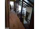 Hallway with wood beams, railings, carpet and view to other parts of the house at 402 Emmett St, Riverdale, GA 30274