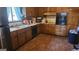 Cozy kitchen with ample wooden cabinets, a double sink, and black appliances at 402 Emmett St, Riverdale, GA 30274