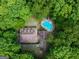 Aerial view of a wooded property with a beautiful in-ground pool at 31 Butler Bridge Dr, Mcdonough, GA 30252