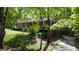 Beautiful brick home with a covered porch, surrounded by lush greenery at 31 Butler Bridge Dr, Mcdonough, GA 30252
