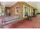 Comfortable back porch with rocking chairs and wooden swing for outdoor enjoyment at 31 Butler Bridge Dr, Mcdonough, GA 30252