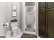 Bathroom featuring a standing shower, toilet, and dark wood cabinets at 31 Butler Bridge Dr, Mcdonough, GA 30252