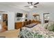 Primary bedroom suite with fan, TV, ensuite, and decorative bedding at 31 Butler Bridge Dr, Mcdonough, GA 30252