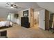 Large bedroom with ceiling fan and doorway that leads to the hallway and stairs at 31 Butler Bridge Dr, Mcdonough, GA 30252