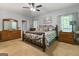 Spacious primary bedroom showcasing matching dressers, a ceiling fan, and bright windows at 31 Butler Bridge Dr, Mcdonough, GA 30252