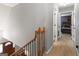 Hallway near stairs showing door to bedroom with dark furniture at 31 Butler Bridge Dr, Mcdonough, GA 30252