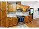 Traditional kitchen with stainless steel appliances, wooden cabinets, and hardwood floors at 31 Butler Bridge Dr, Mcdonough, GA 30252