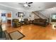 Open-concept living room featuring hardwood floors, staircase, and leather furniture at 31 Butler Bridge Dr, Mcdonough, GA 30252