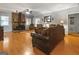 A spacious living room features hardwood floors, a brick fireplace, and leather furniture at 31 Butler Bridge Dr, Mcdonough, GA 30252