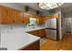 Well-lit kitchen featuring ample counter space, wooden cabinets, and stainless steel appliances at 31 Butler Bridge Dr, Mcdonough, GA 30252