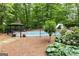 Secluded backyard pool area with landscaping, gazebo, and slide at 31 Butler Bridge Dr, Mcdonough, GA 30252