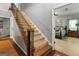 Interior staircase featuring carpeted steps, wood trim, and iron spindles at 31 Butler Bridge Dr, Mcdonough, GA 30252