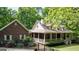 Charming brick home with a wide covered porch, mature landscaping, and a private backyard at 31 Butler Bridge Dr, Mcdonough, GA 30252