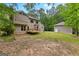 Two-story home featuring a backyard with a wooden deck and surrounded by lush greenery and trees at 155 Grandview Trce, Fayetteville, GA 30215