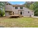 Two-story home showcasing a backyard with deck, surrounded by lush greenery and tree views at 155 Grandview Trce, Fayetteville, GA 30215