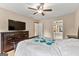 Bedroom featuring wood flooring, and light-colored walls, with a dark dresser and TV in the corner at 155 Grandview Trce, Fayetteville, GA 30215