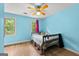 Cozy, bright bedroom with wood floors, blue walls, and natural light from the windows at 155 Grandview Trce, Fayetteville, GA 30215