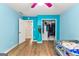 Bright, blue bedroom with wood floors, closet and a doorway to another room create a welcoming atmosphere at 155 Grandview Trce, Fayetteville, GA 30215