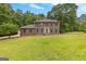 Stately brick two-story home with a large front yard and lush trees at 155 Grandview Trce, Fayetteville, GA 30215