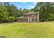 Well-maintained two-story brick home featuring a large front yard with mature trees at 155 Grandview Trce, Fayetteville, GA 30215