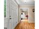 Bright foyer featuring gleaming hardwood floors and a glimpse into the dining area at 155 Grandview Trce, Fayetteville, GA 30215