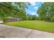 A charming two-story brick home with vibrant green shutters sits on an expansive lawn at 155 Grandview Trce, Fayetteville, GA 30215