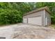 Two-car garage with concrete driveway and adjacent lawn providing ample parking and storage at 155 Grandview Trce, Fayetteville, GA 30215